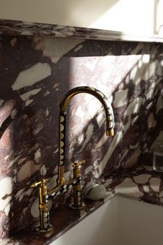 a marble sink and faucet in a bathroom