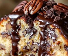 a bundt cake with chocolate frosting and pecans on top, drizzled with chocolate