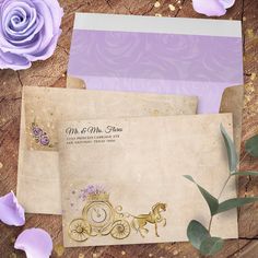 two envelopes with purple flowers on them and one has a gold horse drawn carriage