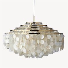 a chandelier made out of shells hanging from a ceiling