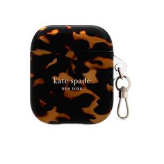 an airpods case with a keychain hanging from it's side and the words kate spade on it