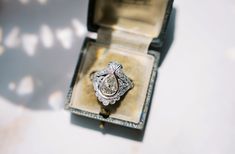 an engagement ring sits in a box on a table