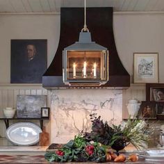 a kitchen with an oven and some pictures on the wall above it, along with other items