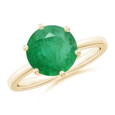 an oval green emerald ring with two yellow gold rings on each side and the center stone in