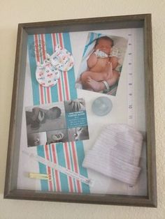 a baby's photo hanging on the wall next to other items in a frame