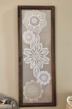 a white crocheted wall hanging next to a sink