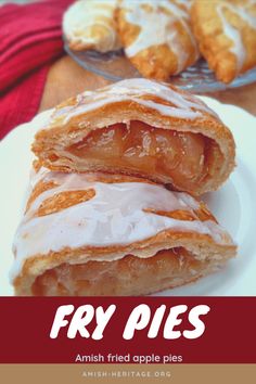 two pieces of pastry sitting on top of a white plate next to a red towel