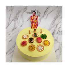 a yellow cake topped with a figurine of a man on top of it