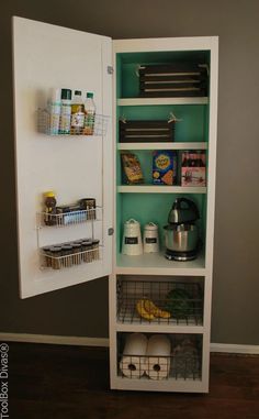 an open refrigerator door with shelves and food items in the bottom section, on top of a hard wood floor