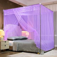 a bed with a purple canopy over it in a bedroom next to a night stand