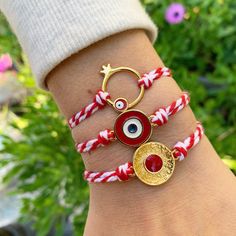 March Bracelets by Irene Andrea Jewelry *Well let's see Evil Eye's symbolism!  In many cultures, the evil eye is regarded as a symbol of Protection from the negative energy, while it attracts positivity! These bracelets, made of red and white cord, are called ''Martis''! In Greece we wear them from the beginning  to the end of March, as the tradition is that they are protecting us, so we will not get burned by the early spring sun of March! But off course, you can wear it also after March! If yo Handmade White Good Luck Bracelets, Gold Braided Evil Eye Bracelet As A Gift, Gold Braided Bracelet With Evil Eye As Gift, Gold Braided Bracelet With Evil Eye For Gift, Symbolic Handmade Bracelets For Friendship, Symbolic Friendship Bracelets, Symbolic Handmade Friendship Bracelets, Symbolic Red Jewelry For Friendship, Handmade Symbolic Charm Bracelet For Friendship