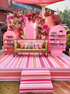 a pink and orange stage set up for a party