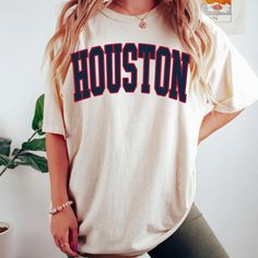 Comfort Colors Houston Football Shirt, Houston Football Sweatshirt, Vintage Style Houston Football shirt, Houston Football fan Gift -Please check Color and Size Charts before placing the order. You can find them in the listing's photos (Depending on what device you are viewing this listing colors may vary slightly). -Returns and exchanges are accepted only if there are defects "No Extra Costs" We create custom t-shirts with great designs for everyone's liking. If you don't find the size or color you would like, please message us and we will be happy to  accommodate! Comfort Colors Houston Football Shirt, Houston Football Sweatshirt, Vintage Style Houston Football shirt, Houston Football fan Gift PRODUCT T-shirt Comfort Colors® 1717     Medium fabric (6.1 oz/yd² (206.8 g/m     Relaxed fit Cotton Varsity T-shirt With Lettering, Casual T-shirt With Lettering For Fans, Varsity Style Fan Gear T-shirt With Lettering, Varsity Fan Gear T-shirt With Lettering, Varsity Lettering T-shirt For Fan Gear, Crew Neck Tops With Lettering For Fan Gear, Crew Neck Tops With Lettering For Fans, Casual Tops With Fan Gear Lettering, Casual Tops With Lettering For Fan Gear