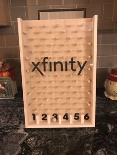 a sign that says xfinity on it in front of a kitchen counter top