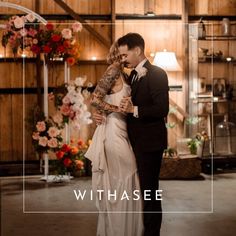 a bride and groom standing in front of a floral display with the words withasee on it