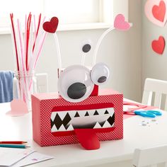 a valentine's day treat box with paper monsters on it