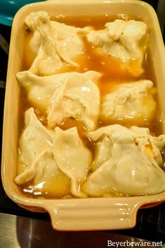 some dumplings are sitting in a yellow dish