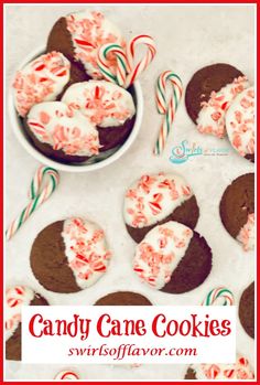 candy cane cookies with white frosting and peppermints in the middle on a table