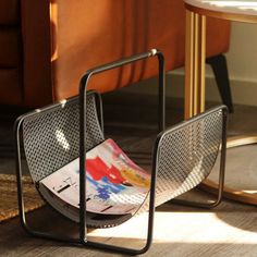 a chair with a magazine rack on the floor