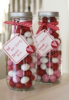 two glass jars filled with valentine's day candies