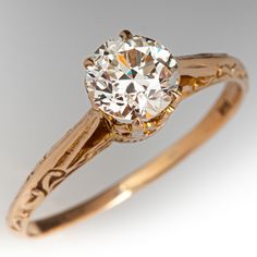 an antique diamond engagement ring with filigree details