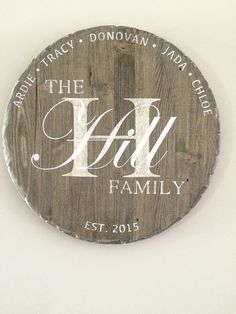 a wooden sign that says the hill family with white lettering on it and an initial