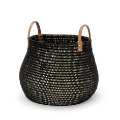 a black and white basket with leather handles