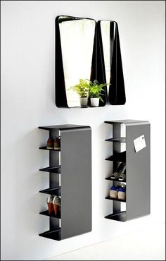 a mirror and shelf with shoes on it in front of a wall mounted planter