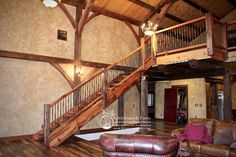 a living room filled with furniture and a wooden staircase