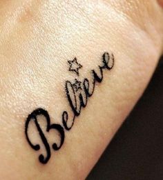 the word believe written in cursive writing on someone's left wrist tattoo