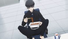 a man sitting on a chair holding a box of food