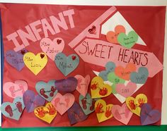 valentine's day bulletin board with hearts and handprints