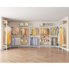 an organized closet with white shelving and wooden floors