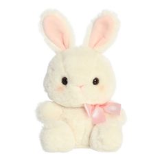 a white stuffed rabbit with a pink ribbon around its neck and ears, sitting up against a white background