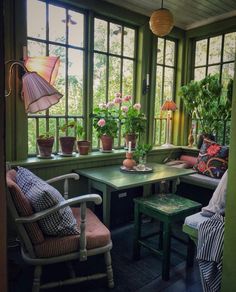 a room filled with lots of plants and furniture