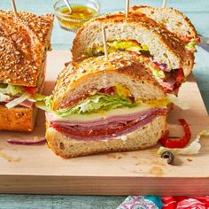 a cut in half sandwich sitting on top of a cutting board