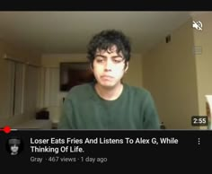 a man is looking at the camera while wearing a green shirt