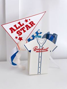 an all star baseball themed gift box with a paper hat and t - shirt on it