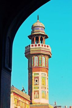 a tall tower with a clock on it's side