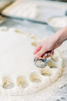 a person is kneading dough on top of a table