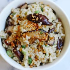 a white bowl filled with rice and vegetables