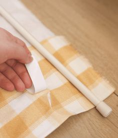 a person is cleaning the table with a cloth and two chopsticks