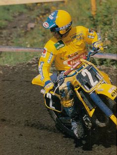 a man riding on the back of a yellow dirt bike