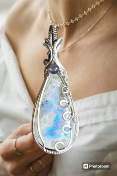 What a beautiful Moonstone!    great blue/purple flashes with so much depth and interesting inclusions. Also accented with an Amethyst in the middle. It's hand wrapped in sterling silver  and hand polished to a brilliant shine. It comes hanging from a 20"  stainless steel chain, so you can wear right away. Unique Silver Mineral Crystal, Handmade Silver Amethyst Crystals, Mystical Silver Gemstone Crystals, Mystical Silver Mineral Crystal, Unique Silver Crystals With Natural Stones, Silver Fluorite Gemstone Jewelry, Handmade Silver Crystals For Jewelry Making, Silver Fluorite Jewelry With Natural Stones, Silver Fluorite Jewelry As A Gift