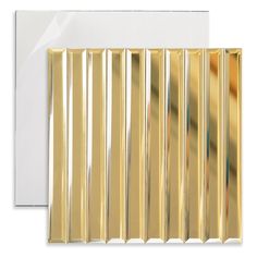 a white envelope with gold foiled stripes on the front and back of the envelope