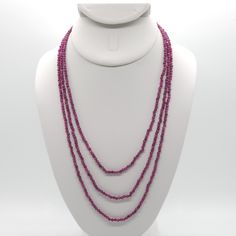 This triple strand necklace is made from all natural all 3mm faceted Natural Ruby done on silk.  It has gold-plated sterling silver and high quality stainless steel findings.  It's finished with a high quality stainless steel magnetic clasp.  The three strands are 17", 19" and 21" with one strand hanging lower than the other. Ruby is a stone of protection and is July's birthstone.  It promotes a positive, outgoing attitude and provides warm energy in darker times.  Ruby is great for uplifting a Faceted Multi-strand Necklace As Gift, Faceted Multi-strand Necklace For Gift, Multi-strand Crystal Necklaces With Faceted Beads, Multi-strand Crystal Necklace With Faceted Beads, Triple Ring, Attitude Positive, Ruby Beads, July Birthstone, Natural Ruby