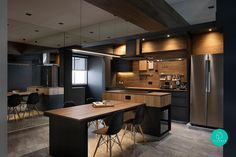 a modern kitchen with black cabinets and wood accents