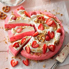 a cake with strawberries and pretzels on top