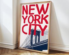 a framed new york city poster on the wall next to a wooden parquet floor