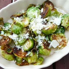 brussel sprouts topped with parmesan cheese in a white bowl